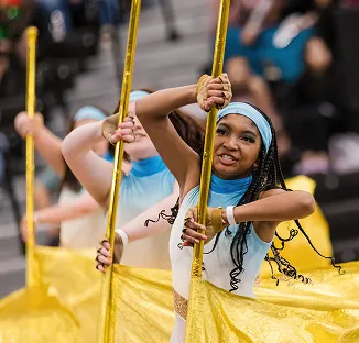 Color guard performers holding gold flags